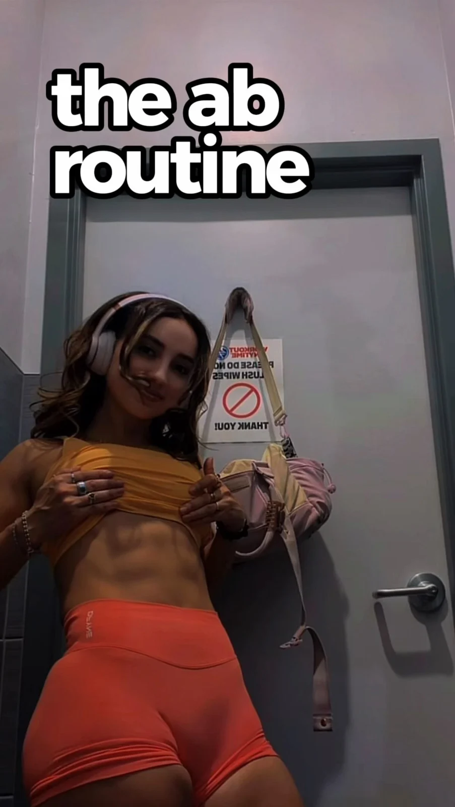 Original cover of Natasha’s ab routine, wearing orange shorts